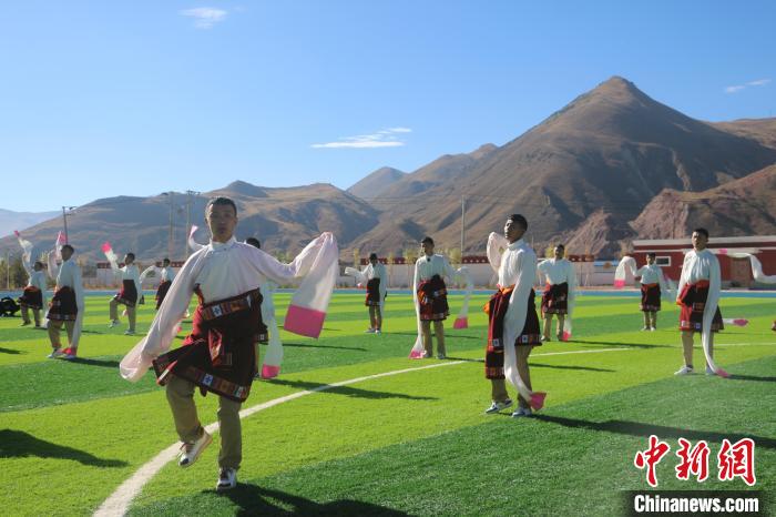 圖為青海師范大學(xué)附屬玉樹實(shí)驗(yàn)學(xué)校學(xué)生在綠茵場跳起囊謙古舞—卓根瑪?！〕逃?攝